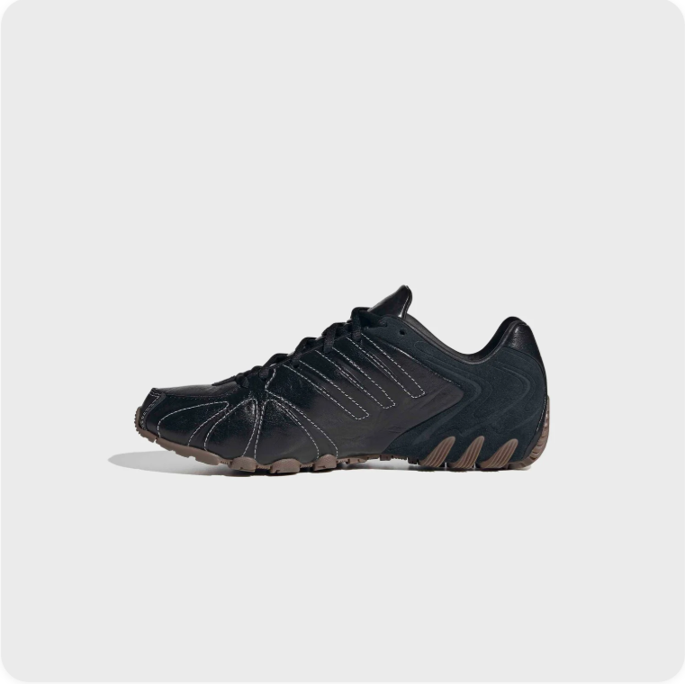 Black Low-Top Sneakers – Contrast Stitching & Brown Sole Accents